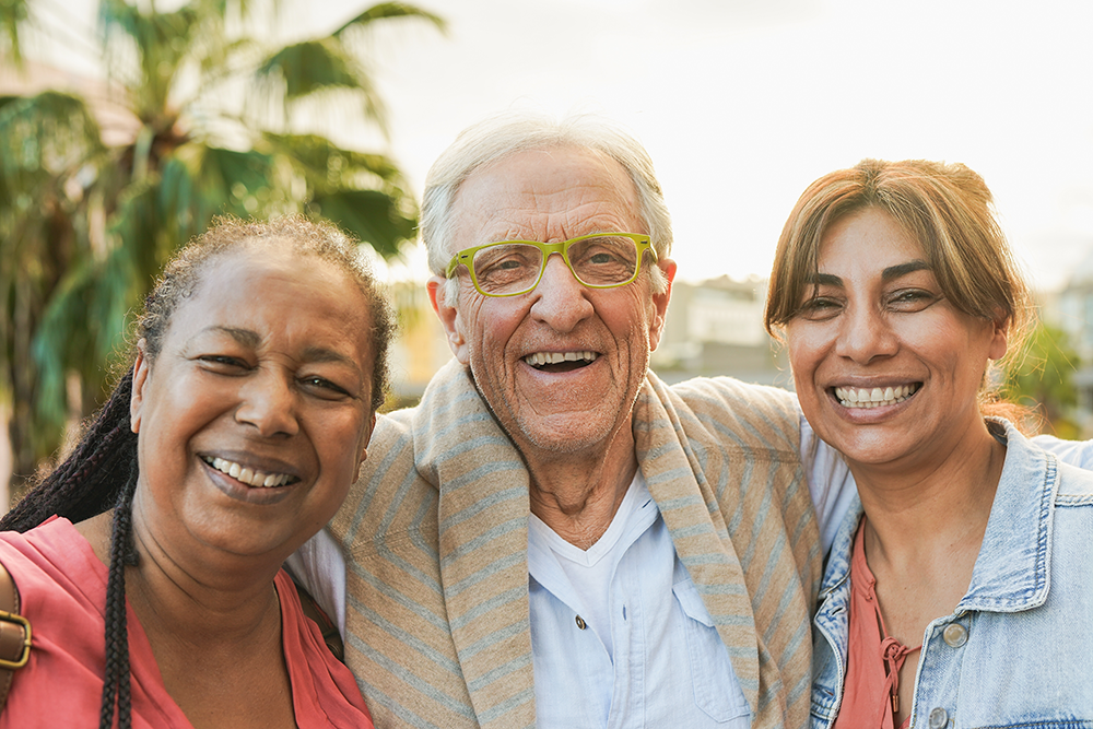 A diverse group of older adults smile for a group picture